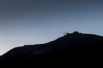 Silhouette of a mountain with cable car in the soft light of dawn, Saalbach Hinterglemm, Salzburg,