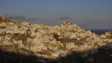 Hill town in the coming sunshine, the light and the shadows give depth, Colourful mountain village,