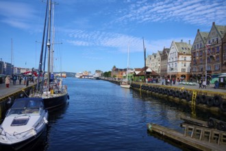 Picturesque harbour with boats, historic buildings, blue sky, Bryggen, Bergen, Vestland, Norway,