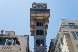 Historic Gothic style lift in Lisbon, rising between old buildings and standing out against a clear