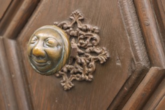 Stahlesches Schwesternhaus in the street Eisgrube in Bamberg. Doorknob with a cheerful face, known