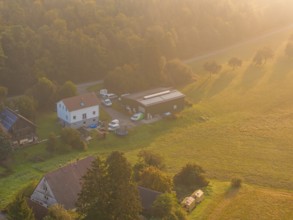 Close-up of a house with surrounding trees and meadows at dusk, Gechingen, Black Forest, Germany,