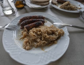 Sausages with sauerkraut and bread served in a Franconian restaurant, Bavaria, Germany, Europe