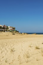 Colourful holiday homes and beach, Monte Clérigo, Atlantic coast, Algarve, Portugal, Europe