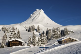 Snow-covered mountains and mountain hut with ski slope, Damülser Mittagspitze, Damüls,