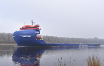 Cargo ship, heavy goods transporter, Bravewind sails in winter in the Kiel Canal, NOK, Kiel Canal,