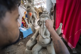 Artisan work on idols of the elephant-headed Hindu deity Ganesha at a workshop ahead of the Ganesh