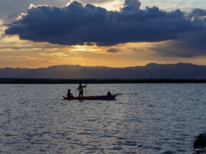 Fishermen and fishing boat in the evening light, Tempe Sea, Sulawesi, Indonesia, Asia