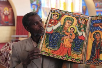 Tigray region, Axum, Aksum, St Mary's Cathedral, Maryam Tsion, inside, church servant shows old