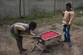 Two boys are playing billiards at Fianarantsoa, Madagascar, Africa