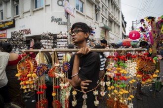 A boy sells decorative items at a street market ahead of Durga Puja festival on October 7, 2024 in