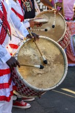 Drummers with rustic and colorful wooden drums at an Afro-Brazilian cultural event on the streets