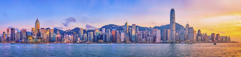 Panorama of Hong Kong skyline cityscape downtown skyscrapers over Victoria Harbour in the evening