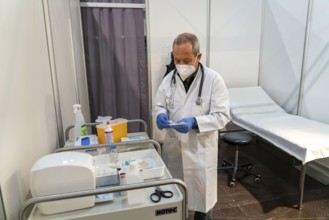 Vaccinator prepares a vaccination, during the test run in the vaccination centre for the corona