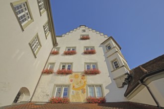 Historic gate castle with stepped gable, oriel and wall painting, wall painting, view upwards, town