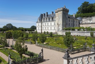 Historic castle surrounded by an overgrown garden with hedges and well-tended paths, Villandry