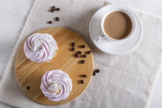 Cakes with whipped egg cream on linen napkin. top view, copy space