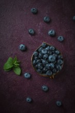 Fresh berries, Blueberries, on a maroon background, food concept, vertical, no people