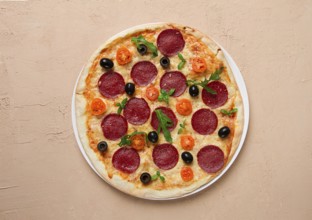 Pepperoni pizza, with olives and cherry, homemade, on a beige background, top view, no people