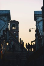 Tourists as silhouette on the Rialto Bridge in the last evening sun, crowded, full, city trip,