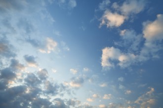 Fleecy clouds adorn the blue evening sky