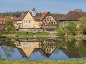 Church and historical houses of village Winterhausen, river main, reflections on the water, east of