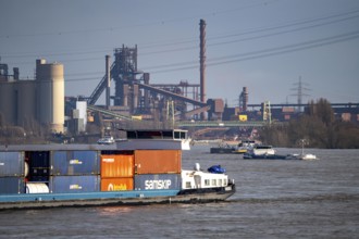 The Rhine near Duisburg, cargo ships, backdrop of the ThyssenKrupp Steel steelworks in Duisburg