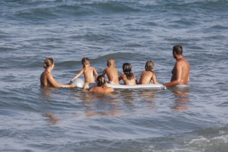 Families with children on an air mattress on the beach of Diano Marina, Italy, 14/08/2024, Diano