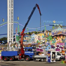 Setting up fairground shops under a blue sky in the morning, Cranger Kirmes, Herne, Ruhr area,