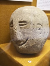 Human face carved onto stone. With permission of Wiltshire Museum, Devizes, England, UK