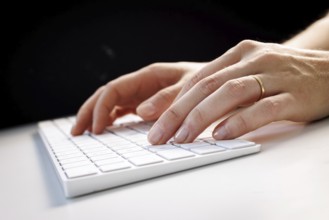 Hands typing on a keyboard in Berlin, 09/08/2024