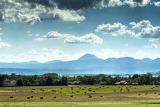 View of the Chain of Volcanoes and Limagne plain under a vibrant sky in Puy-de-Dôme,