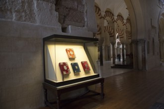 Glass display case of historic bible books inside the cathedral, former Great mosque, Cordoba,