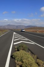 Chevron road lines on main highway through Malpaís Grande national park, Fuerteventura, Canary