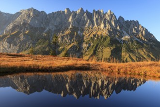 Rugged mountains reflected in a small mountain lake, autumn, evening light, Hochkönig, Mandlwand,