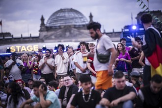 Scenes in the fan zone on Platz der Republik in front of the Reichstag building taken in Berlin, 29