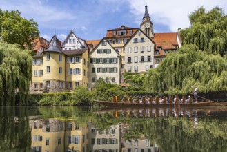 Neckarfront Tübingen with punt on the Neckar. Postcard motif with historic buildings, collegiate