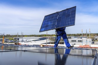 Installation of solar modules on the roof of a commercial enterprise, over 400 photovoltaic modules