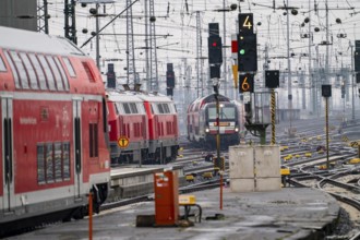 Railway tracks with regional trains, after freezing rain, in front of Frankfurt main station,