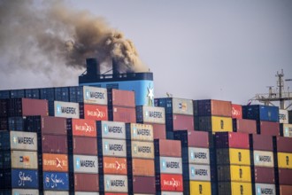 Container freighter Madison Maersk smoking chimneys of the ship's diesel engines, Maasvlakte 2,