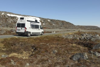 Campervan/caravan on a lonely coastal road through the tundra near Hamningberg on the Barents Sea,