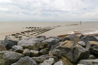 Fishtail reef coastal defences and rock armour at high tide, Cobbold's Point, Felixstowe, England,