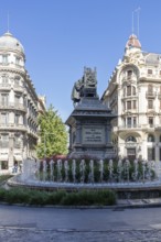 Magnificent monument and bubbling fountain amidst historic buildings in a town square, Granada