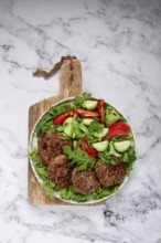 Fried cutlets, mixed minced meat, with vegetable salad, homemade, top view, no people