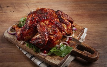 Whole fried chicken, with spices, grilled chicken, on a chopping board, top view, homemade, no