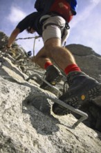 Close up of mountaineering boot of alpine climber climbing Via ferrata in the Zillertal, Tyrol,