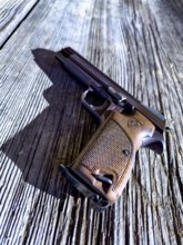 Old Elegant Handgun on an Old Wood Table in a Sunny Day, Made in Switzerland