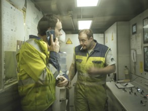 Workers in a control room of the double shield tunnel boring machine in section H53 of the Brenner