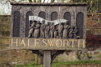 Carved wooden sign showing history of Halesworth, Suffolk, England, United Kingdom, Europe