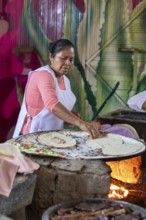 Santa María del Tule, Oaxaca, Mexico, A worker at the Restaurant Familiar Reynita cooks on a comal